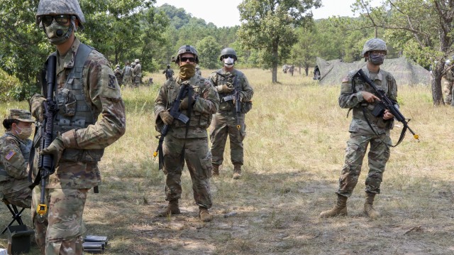 Army Warrior Tasks fire team lanes tested Army Reserve Soldiers on individual and team-based skills needed to maintain their individual and unit readiness while adhering to the Defense Department training guidelines to prevent the spread of COVID-19. Sergeant Bryce Dickerson, center left, and Pfc Alex Stone, right, prepare to conduct their lane with other members of the 993rd Transportation Medium Truck Company at Fort McCoy, Wis., August 25, 2020.