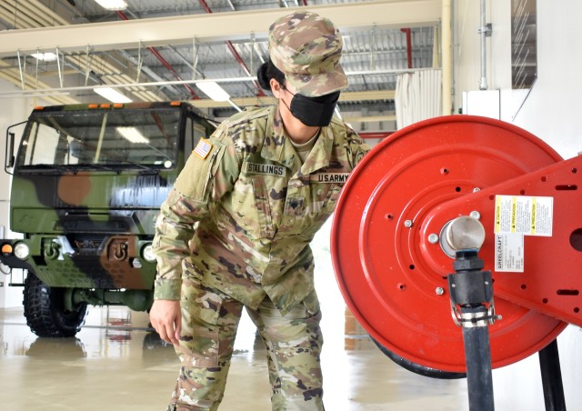 Spc. Brianna Stallings, assigned to the 38th Air Defense Artillery Brigade, rolls up a hose at the U.S. Army Garrison Japan Wash Rack at Sagami General Depot, Japan, Sept. 21.