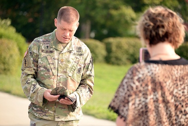 Catholic Chaplain (Maj.) Jason Hesseling says a prayer during the Women of St. Ignatius/Catholic Women of the Chapel kick-off event as Michelle Taylor, Catholic community coordinator, runs the Facebook Live feed Sept. 17 outside Frontier Chapel. Photo by Prudence Siebert/Fort Leavenworth Lamp
