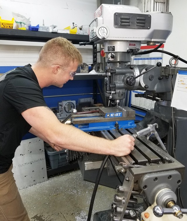 Class of 2021 Cadet Eston Smith is machining a part for a AH-64 Apache during an Academic Individual Advanced Development program in Anaheim, California, in the summer of 2019.  Courtesy Photo