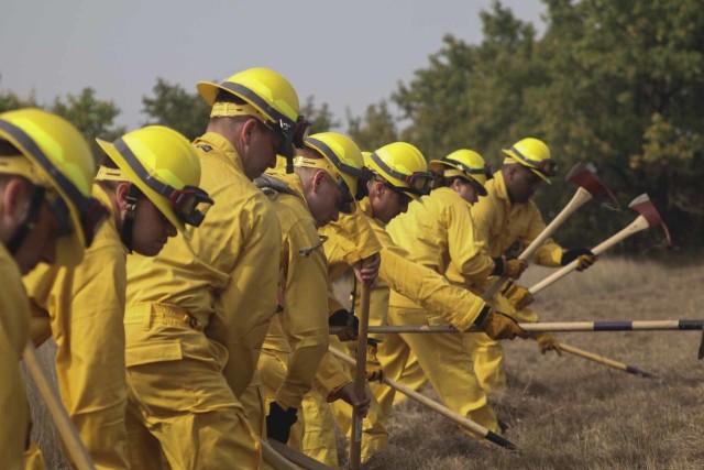 Kansas Army and Air National Guard students practice line-digging techniques during the field training day portion of the Wildland Firefighting Red Card Certification Course that took place at the Great Plains Regional Training Center in Salina...