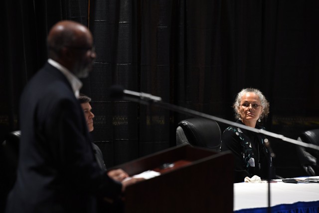 Ann Garner, director of the Directorate of Public Works, watches as James Harper with Fort Jackson Family Homes speaks about the money spent on housing repairs during the Community Town Hall Sept. 16.
