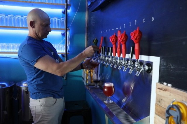 Retired Army Chief Warrant Officer 3 Jeremy Boucher, a Springfield, Massachusetts-native, pours a drink for a customer at Split Fin Brewery in Midway, Ga., Sept. 17, 2020. Jeremy and Dr. Kristen Boucher are both Army veterans and they opened Split Fin Brewing in June. The couple credits much of their business’ success to the skills they gained while serving in the Army.