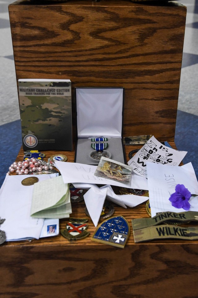Coins, notes and mementos cover the memorial of Pvt. Michael Wise at the Solomon Center Sept. 19.
