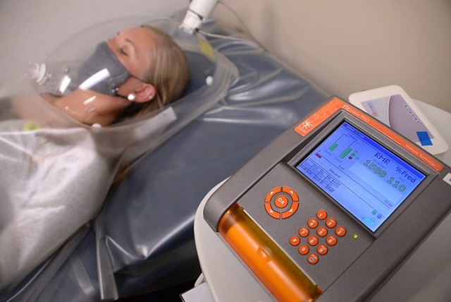 Christine Cunningham, Army Wellness Center health educator, demonstrates having her oxygen utilization measured to find her resting metabolic rate Sept. 21 at the AWC in Eisenhower Hall. The resting metabolic rate is the amount of energy needed in a 24-hour period when completely at rest. The rate determines how many base calories are needed, and then calories needed for normal activities and exercise are considered to maintain, lose or gain weight. Photo by Prudence Siebert/Fort Leavenworth Lamp