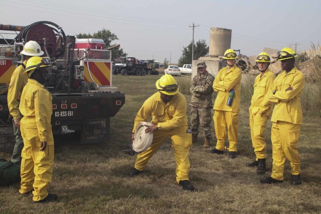 Spc. Mori Semo, M1 armor crewman with 2nd Combined Arms Battalion, 137th Infantry Regiment, from Wichita, Kansas, practices unrolling a segment of hose during the field training day portion of the Wildland Firefighting Red Card Certification Course that took place at the Great Plains Regional Training Center in Salina Sept. 17. The objective of the course, which was made possible through a partnership between the Kansas National Guard and the Kansas Forest Service, was to increase statewide wildland firefighting capabilities by certifying Guardsmen across the state to respond to wildfires.