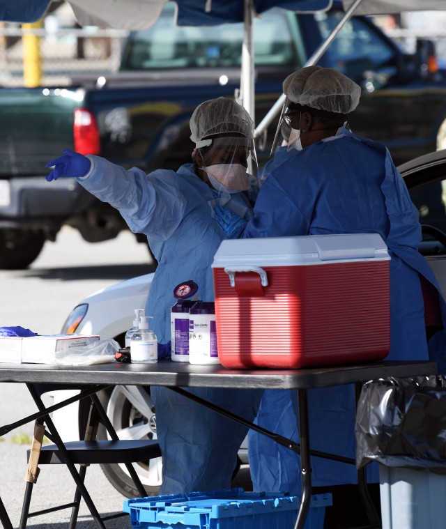 Workers from the Medical University of South Carolina wipe off each others protective equipment after administering a test during drive thru COVID testing at Fort Jackson Sept. 22. MUSC and Fort Jackson offered the testing Sept. 22 and 24 to the...