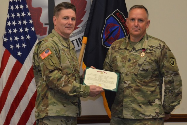 Col. Phil Ryan, commander, USASOAC, presents Command Sgt. Maj. James D. Wilson, outgoing USASOAC command sergeant major, with a Legion of Merit for Wilson’s hard work, dedication and commitment while serving as the senior enlisted Soldier. Wilson will move on to serve as the command sergeant major for the U.S. Army Aviation Center of Excellence at Fort Rucker, Alabama. (Photo by Capt. Veronica Aguila, USASOAC public affairs)