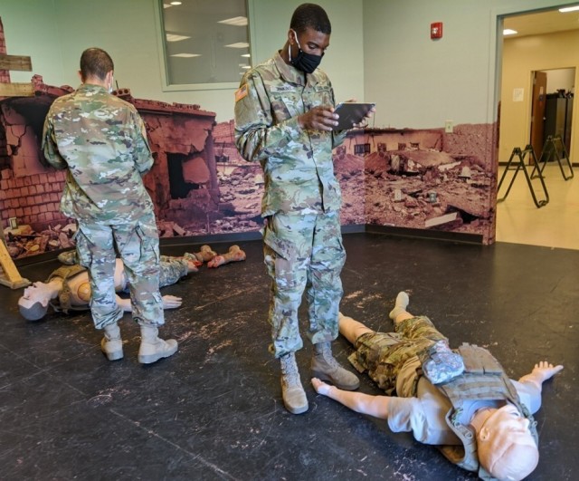 A pair of Army Soldiers use the tablet version of the AUGMED virtual reality training tool during an ALS course at Fort Indiantown Gap on September 22. (Photo Credit: Dr. Cali Fidopiastis, Design Interactive, Inc.)