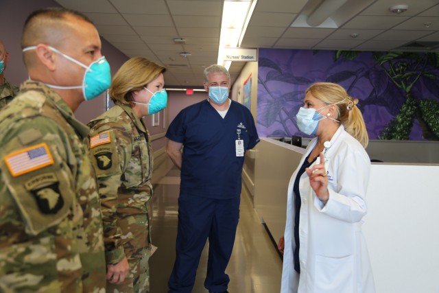 Ms. Zahra Garza, right, an executive director at the Sky Tower, United Health System, talks to Army Lt. Gen. Laura J. Richardson, second from left, commanding general of U.S. Army North and Joint Force Land Component Command, and Army Command Sgt....