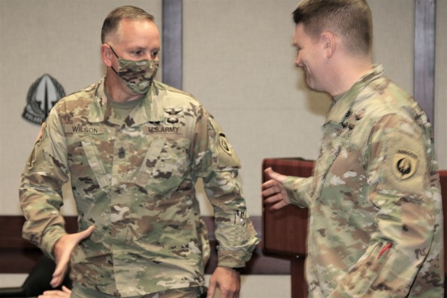 Col. Phil Ryan, commander, USASOAC, congratulates Command Sgt. Maj. James D. Wilson, outgoing USASOAC command sergeant major, at Fort Bragg, North Carolina, Sept. 25, for a successful tour serving as the top enlisted Soldier of the command. Wilson’s next assignment is as the command sergeant major of the U.S. Army Aviation Center of Excellence at Fort Rucker, Alabama. (Photo by Master Sgt. Shannon Blackwell, USASOAC public affairs)