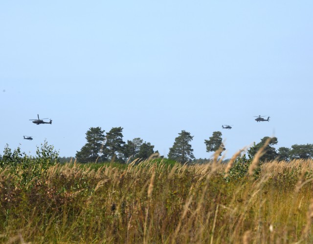 AH -64 Apache helicopters from the U.S. 1-101st Combat Aviation Brigade flying over the engagement area during the Wojtek Fire Exercise.