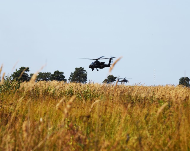 AH -64 Apache helicopters from the U.S. 1-101st Combat Aviation Brigade flying over the engagement area during the WOJTEK FIRE Exercise.