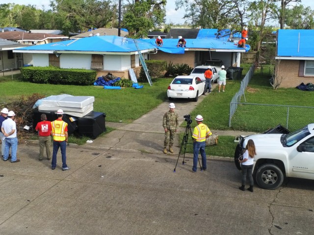 Col. Zach Miller, Memphis District Corps of Engineers, speaks with USACE broadcaster Michael Glasch, Omaha District, in Lake Charles, La., Sept. 27, 2020, where contractors are working on the 5000th home to benefit from Operation Blue Roof...