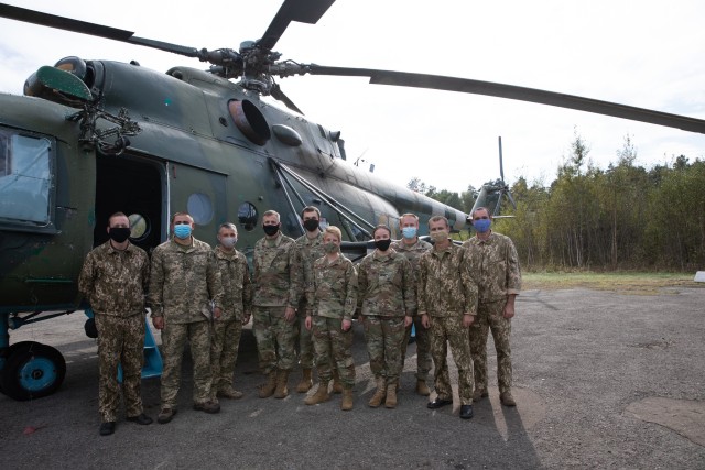 Military Attaché to the U.S. Embassy in Kiev, Airforce Col. Brittany Stewart and Army Attaché Col. Paul Schmitt (front center) from pose for a group photo after riding over Collective Training Center-Yavoriv Ukraine in a Ukrainian Hind...