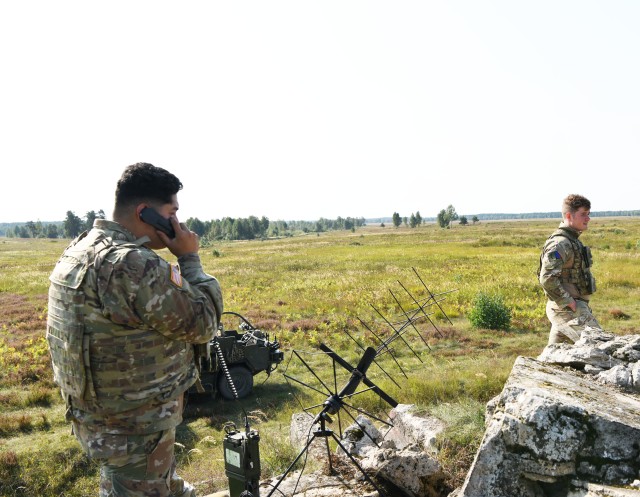 Pvt. Qoeli Jimenez, a communications specialist from 2nd Squadron, 2nd Calvary Regiment, works with British Joint Terminal Attack Controllers during Wojtek Fire Exercise.