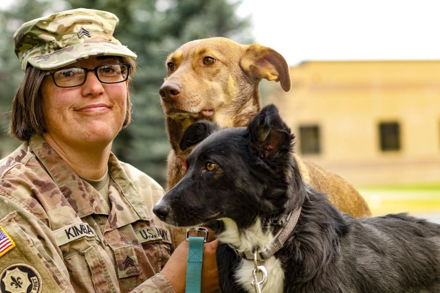 Sgt. Corina Kimball, an intelligence noncommissioned officer from Great Falls, Mont., with the 652nd Regional Support Group, sits with her dogs Cinnamon, left, and Pepper, right, Sept. 14, 2020 at Fort William Henry Harrison, Helena, Mont. The...