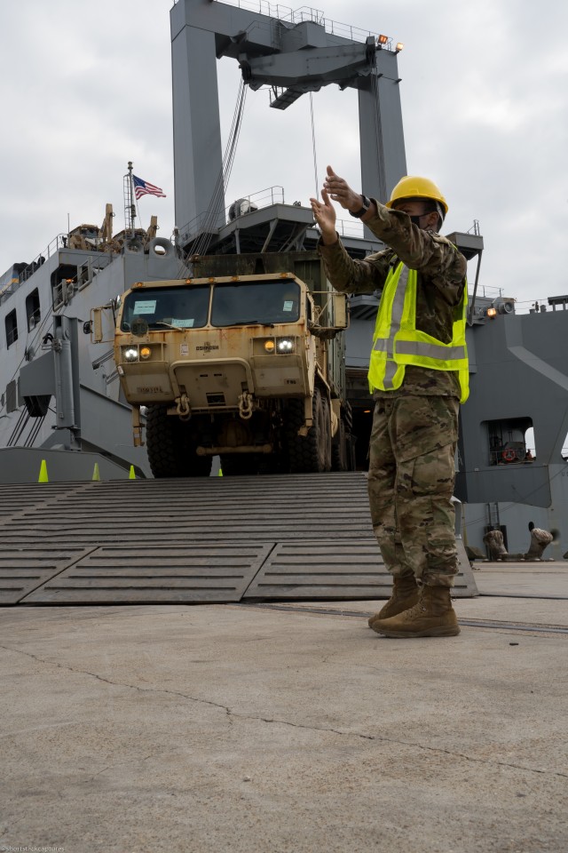U.S. Army Pvt. Martavius Douglas, a Cargo Specialist (88H) with 368th Seaport Operations Company, 11th Transportation Battalion, 7th Transportation Brigade (Expeditionary), directs a vehicle off the U.S. Naval Ship, Fisher, in Port Arthur, Texas,...