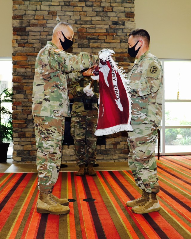 Fort Campbell Soldier Recovery Unit leaders, (from left) Command Sgt. Maj. Angel Rivera and Lt. Col. Heath Holt uncase the SRU colors. The Fort Campbell Warrior Transition Battalion was formally reflagged as the Fort Campbell Solider Recovery Unit during a reflagging ceremony on Fort Campbell, July 10. The SRU, is part of the Army Recovery Care Program, which oversees the evaluation and treatment of wounded, ill and injured Soldiers requiring six months or more of rehabilitative care and complex medical-case management. The name change reflects the restructuring of the program to update policy and procedures, to simplify entry criteria, streamline processes and focus resource s to foster an environment at the unit level that will serve individual Soldiers' unique needs. US Army photo.