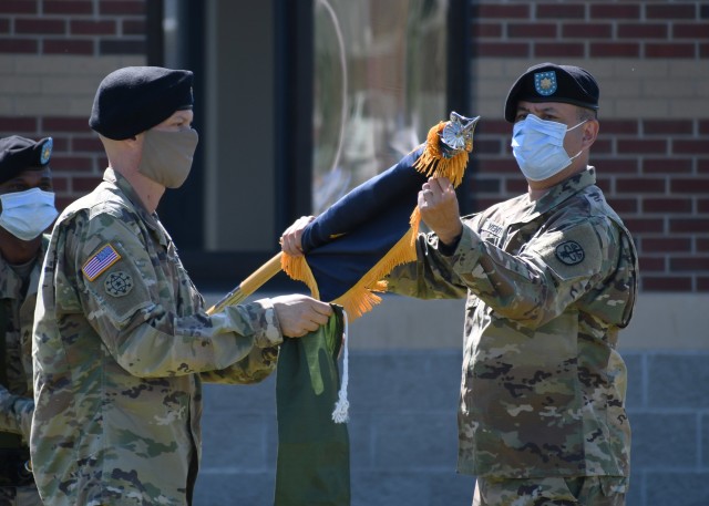FORT DRUM, N.Y. – Lt. Col. Robert P. Venton (right) and Command Sgt. Maj. Gordon Lawitzke (left), the commander and senior enlisted leader respectively of the Fort Drum Soldier Recovery Unit, prepare to case the iconic colors of the 3rd Battalion, 85th Mountain Infantry Regiment Warrior Transition Unit (WTU) during a re-designation ceremony on Fort Drum, N.Y. June 16, 2020.  The WTU was re-designated the Fort Drum Soldier Recovery Unit as part of the Army’s restructuring of the Warrior Care and Transition Program to the Army Recovery Care Program.  The new model of wounded warrior care will simplify entry criteria, streamline processes and focus resources to foster an environment that will serve individual wounded, ill and injured Soldiers. (U.S. Army photo by Warren W. Wright Jr., Fort Drum Medical Activity Public Affairs)