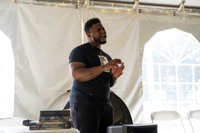 DeAndre Nico, a contestant on the reality show 'The Voice,' sings worship at 7th Trans. Brigade (Expeditionary)'s Sunday Service at Port Arthur, Texas on Sep. 27, 2020. Mr. Nico is a Port Arthur local, invited by Ms. Diane Guidry, owner of "Edith's Place" a resturant that has been contracted to feed 7th TB (X) Soldiers during the excercise.   (U.S. Army photo by Sgt. Marygian Barnes, 22nd Mobile Public Affairs Detachment)