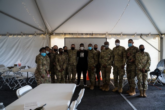 DeAndre Nico, a contestant on the reality show 'The Voice,' takes a photo with 7th Trans. Brigade (Expeditionary) Soldiers during Sunday Service at Port Arthur, Texas on Sep. 27, 2020. Mr. Nico is a Port Arthur local, invited by Ms. Diane Guidry, owner of "Edith's Place," a restaurant that has been contracted to feed 7th TB (X) Soldiers during the exercise.   (U.S. Army photo by Sgt. Marygian Barnes, 22nd Mobile Public Affairs Detachment)