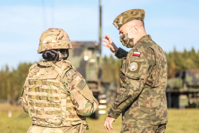 Capt. Mellorie Clinton , Commadner of Delta Battery, 5th Battalion, 7th Air Defense Regiment explaining the Patiot Site layout to Capt. Bartosz Rozek, Commander of the Polish 3-7 Air Defense Squadron during exercise Astral Knight 20 at Szymany Air Base, Poland, Sept. 22, 2020. Astral Knight 20 is a joint, multinational exercise involving Soldiers and Airmen from the United States working with service members from Poland, Latvia, Lithuania, Estonia, and Sweden. (U.S. Army photo by Capt. Rachel Skalisky)