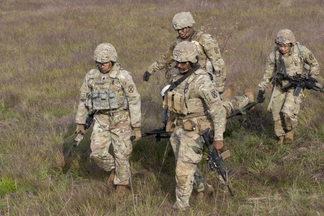 Pvt. Estephania Zarate-Rivas (right), an infantryman with 1st Platoon, Cohort Company, 2nd Battalion, 14th Infantry Regiment, 2nd Brigade Combat Team, 10th Mountain Division (LI), assists in a litter carry during a Combined Arms Live-Fire Exercise on Sept. 14, 2020. This was the first CALFEX she ever participated in. 