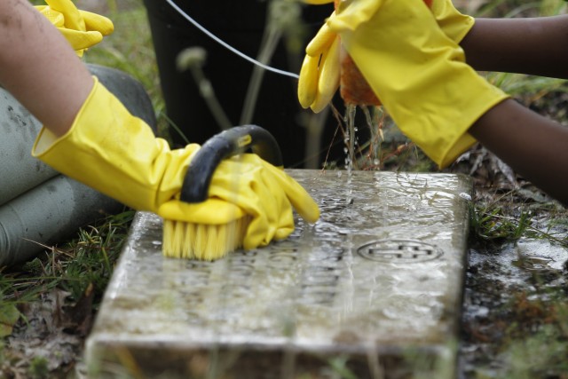 Children of Kessler, Murray and Diamond elementary schools, and other volunteers clean historic headstones and learn proper care and cleaning of various grave markers Sept. 25 at Taylors Creek Cemetery on Fort Stewart in honor of National Public...