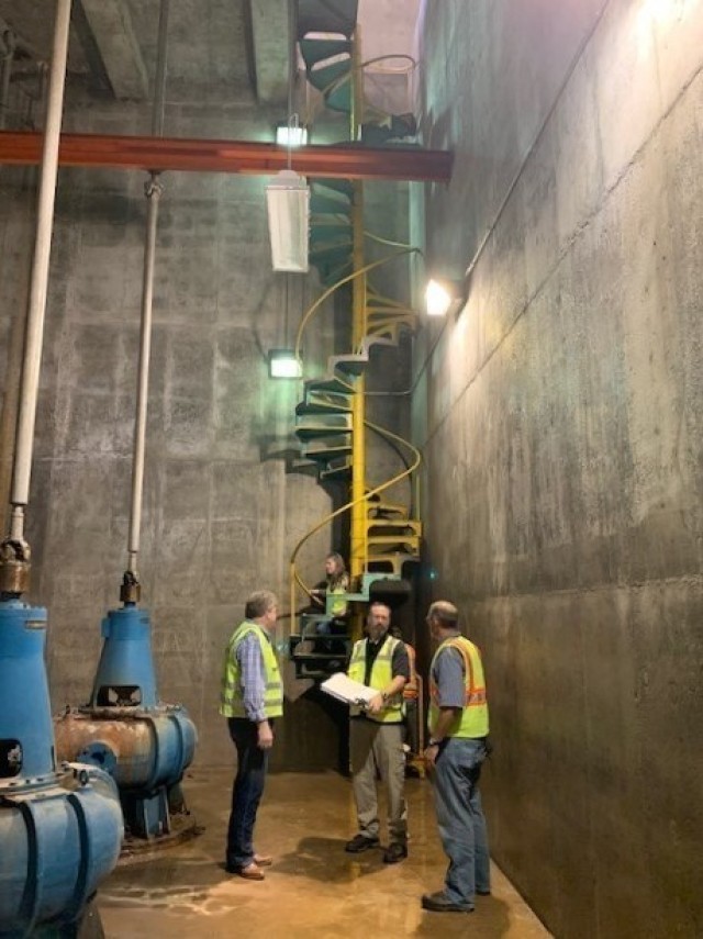 Workers discuss coming improvements inside the 5th Street Pump Station in Kansas City, Kansas September 29, 2020.