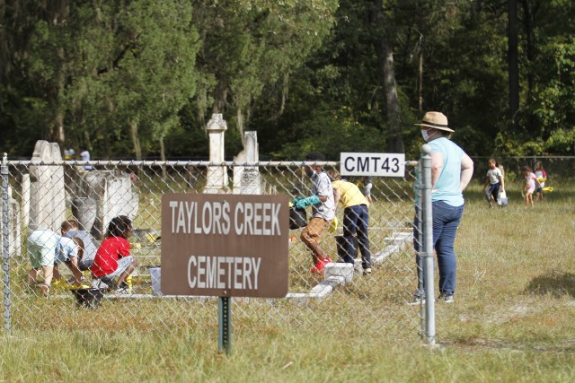 Children of Kessler, Murray and Diamond elementary schools, as well as volunteers clean historic headstones and learn proper care and cleaning of various grave markers Sept. 25 at Taylors Creek Cemetery on Fort Stewart in honor of National Public...