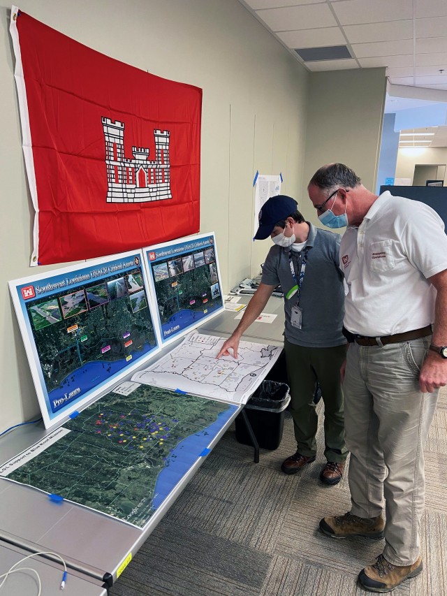 Kyle Gagnier, left, FEMA, geographic information system unit lead, and CJ Hamilton, Corps of Engineers local government liaison, review products FEMA's GIS team created at the Joint Field Office in Baton Rouge, La., Sept. 16, 2020. As an arm of...