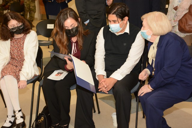 FORT LEE, VA. -- Family members of the late Maj. Gen. Eugene L. Stillions Jr. reminisce as they look through a memory book given to them during a dedication ceremony for a field in his name Sept. 25. His ceremony was one of four Quartermaster...