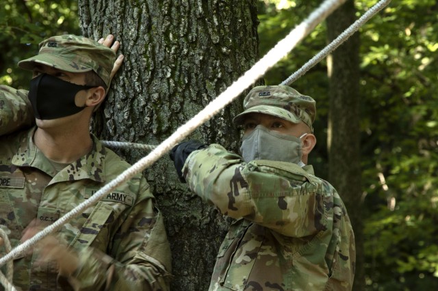 Officer Candidate School Candidates of class 65 work to sharpen their communication and teamwork abilities as they navigate through a balance rope obstacle at the Webster Conference Center in Salina, Kansas, Sept. 13, 2020. “We are looking for...