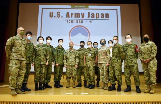 Participants and organizers of the Japan Ground Self-Defense Force Reserve Interpreters Training symposium at Camp Zama, Japan, Sept. 24, pose for a group photograph.