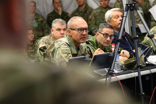 Lt. Gen. Randy George, center, First Corps commanding general, is briefed on priority targets at a briefing during Warfighter Exercise 20-3 on Joint Base Lewis McChord, Washington, Feb. 11, 2020. (U.S. Army photo by Spc. Joseph E.D. Knoch.)