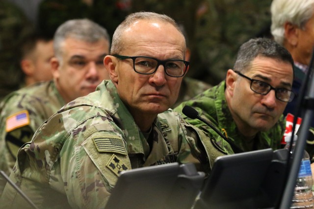 Lt. Gen. Randy George, center, First Corps commanding general, is briefed on priority targets at a briefing during Warfighter Exercise 20-3 on Joint Base Lewis-McChord, Washington, Feb. 11, 2020. (U.S. Army photo by Spc. Joseph E.D. Knoch.)