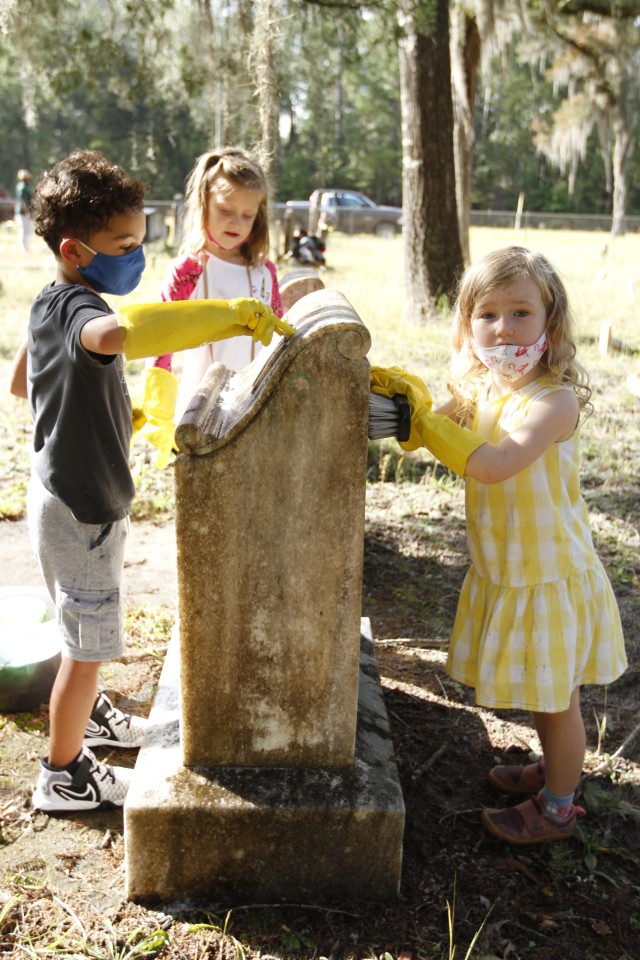 Children from Kessler, Murray and Diamond elementary schools clean headstones Sept. 25 at Taylors Creek Cemetery on Fort Stewart in honor of National Public Lands Day. The children helped clean up half of the nearly 450 headstones in the cemetery...