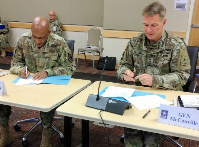 Army Chief of Staff Gen. James C. McConville, right, and Air Force Chief of Staff Gen. Charles Q. Brown Jr. sign a two-year collaboration agreement in the development of Combined Joint All-Domain Command and Control, or CJADC2, which will impact units in both branches Sept. 29, 2020. 