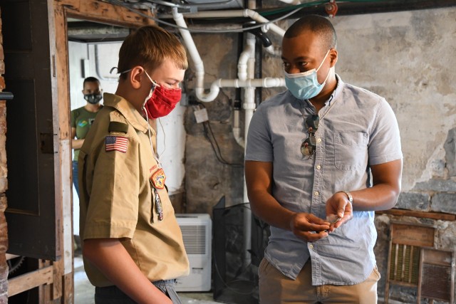 Nathan Lampman, a Scout with Fort Drum’s Troop 26 B, receives an Army pin and coin from William Scott, vice president of the Climb to Glory Chapter of ROCKS, Inc., during a ribbon-cutting ceremony Sept. 26 at LeRay Mansion. Lampman teamed up...