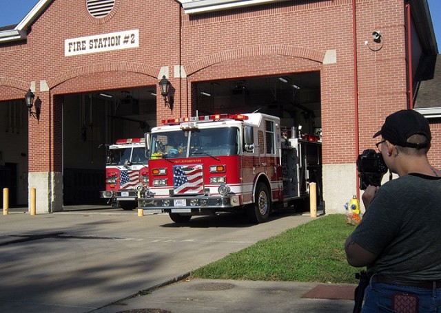 Annika Kinder, Fort Leavenworth Public Affairs intern and senior at Park University, films Fort Leavenworth Fire and Emergency Services firefighters responding to a mock kitchen fire call during the making of a Fire Prevention Week video Sept. 25 at Station No. 2. "Serve up fire safety in the kitchen" is the theme of this year's Fire Prevention Week. Photo by Prudence Siebert/Fort Leavenworth Lamp