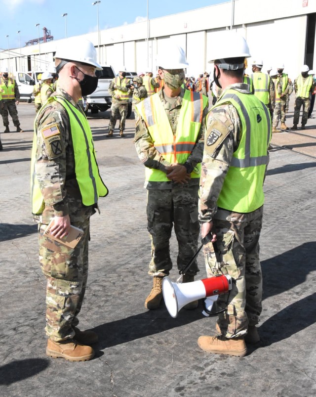 Brig. Gen. Patrick D. Frank, commander, JRTC and Fort Polk (left) and Lt. Gen. Leopoldo Quintas Jr., FORSCOM deputy commanding general (center) are briefed by Capt. Jordan Jendersee, commander, 366th Seaport Operations Company, 7th Transportation...
