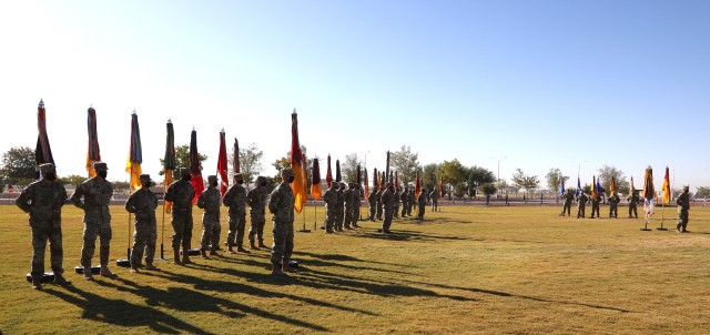 Fort Bliss, Texas – Iron Soldiers stand in formation with the Brigade Colors of the 1st Armored Division during a Change of Command ceremony held on Sept. 30 at Iron Soldier Field. The ceremony honored outgoing 1AD commanding general, Brig. Gen. Matthew L. Eichburg, and formally welcomed incoming commanding general, Brig. Gen. Sean C. Bernabe. To protect the health and safety of the force and community, attendance was kept to a minimum and those that attended practiced social distancing and donned face coverings, per COVID-19 protocols and regulations. (U.S. Army photo by Jean S. Han)