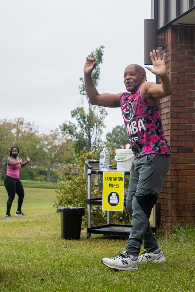 Harry Williams, an instructor with the FMWR Fort Jackson Fitness Department, leads participants in a workout at the Do it in Pink Aerobathon Sept. 26.