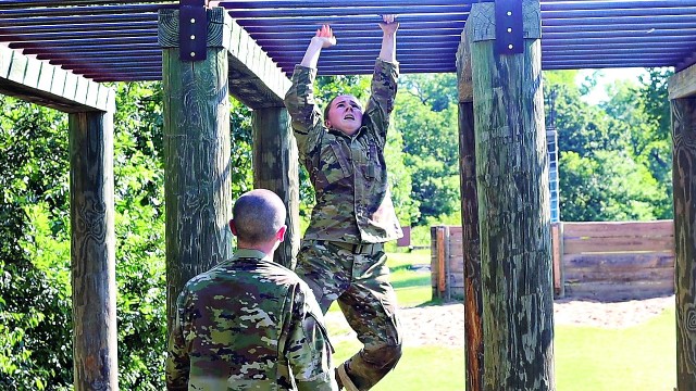 A trainee tests her upper body strength while her teammate waits. The two were chosen as the
strongest in their platoon to run through the Combat Conditioning Course a second time to try to earn the CCC streamer.