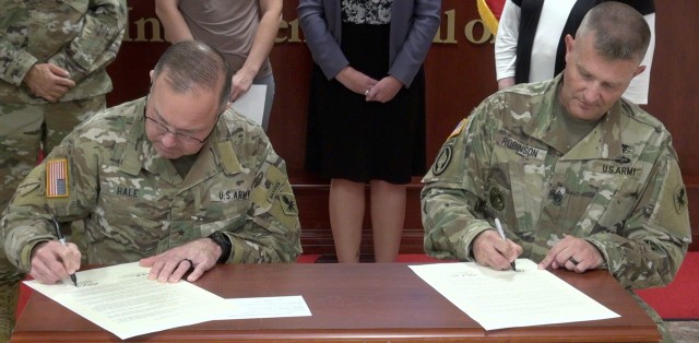 (left to right) Brig. Gen, Anthony Hale, Commanding General, U.S. Army Intelligence Center of Excellence & Fort Huachuca and Command Sergeant Major Warren Robinson sign a proclamation designating October  2020 as Domestic Violence Awareness Month at Fort Huachuca, Ariz.