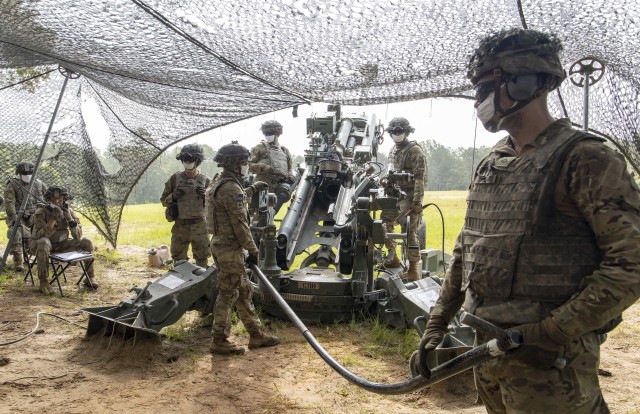 U.S. Army cannon crewmembers assigned to Charlie Battery, 5th Battalion, 25the Field Artillery Regiment, 3rd Brigade Combat Team, 10th Mountain Division, rehearse crew drills at Slagle training area, Fort Polk, La., prior to a firing a M982A1 Excalibur precision munition from a M777 howitzer, June 27, 2020. The training certified C BTRY to provide live fire artillery support to Joint Operations Training Center rotational training units. 