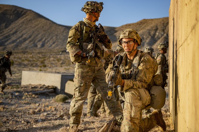 Pfc. Charles Grigalan, infantryman for Alpha Company, 2-136th CAB, pulls rear security for his squad on July 25, 2020 at Fort Irwin, California&#39;s National Training Center.

Soldiers of the 2nd Combined Arms Battalion, 136th Infantry Regiment, conduct a long and grueling, pre-dawn attack as the culminating force-on-force training event at the National Training Center in Fort Irwin, Calif. From Bradley Fighting Vehicles, M1A1 Abrams tanks, and dismounted Soldiers, the 1st Armored Brigade Combat Team, 34th Infantry Division, utilized all assets from its subordinate battalions to reclaim the contested town of Razish from the opposition force known as “Blackhorse.” Blackhorse Soldiers from the U.S. Army’s 11th Armored Cavalry Regiment are dedicated to testing units in “The Box.”

In preparation for the attack on the city of Razish, the 2-136th CAB staged troops for the decisive action movement at 2 a.m. Since “The Box” is considered a contested area, avoiding the use of headlights to remain undetected by the opposition force is key. Drivers employed night-vision goggles paired with ambient light from the moon for the early morning positioning.

Bradleys and tanks moved in unison until infantrymen dismounted and bounded forward to the objective occupied by the enemy. Block-by-block and room-by-room, the town was cleared of enemy combatants and taken by Red Bull Soldiers, and the mission was declared a success.

NTC’s 996-square-mile training range offers brigades the unique opportunity to conduct tough and realistic land operations, giving combat, medical and leadership teams the chance to train in deployment-like conditions. Training rotations include mass-casualty exercises, base attacks, and other contingency training to test and teach Soldiers.