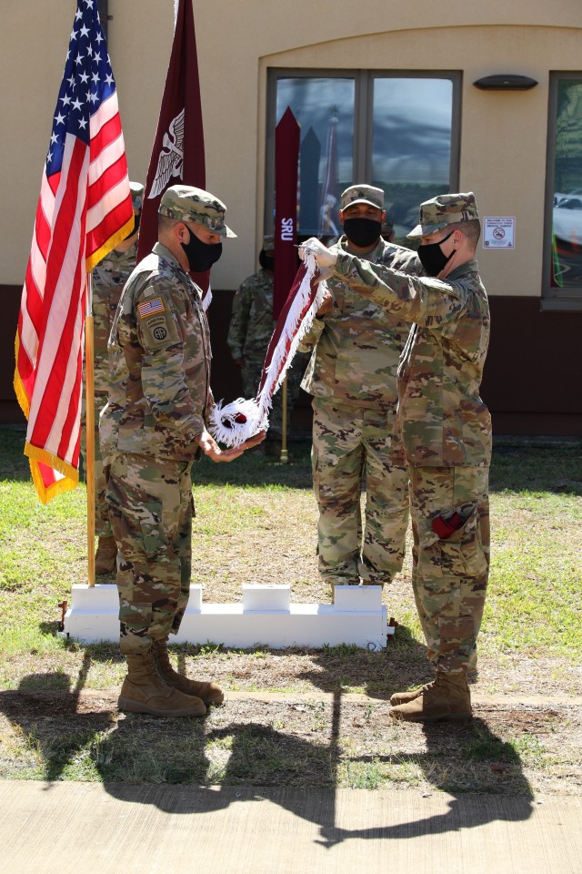Col. Martin Doperak, Tripler Army Medical Center commander and Command Sgt. Maj. Christian G. Davis unveil the new Soldier Recovery Unit's colors.