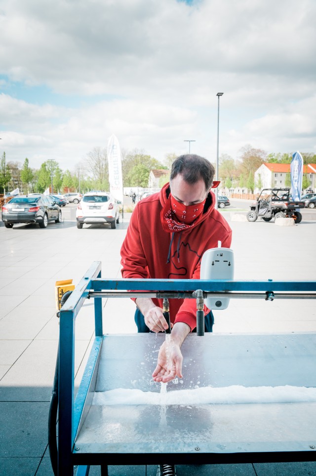 A community member washes his hands outside of The Exchange at U.S. Army Garrison Wiesbaden in April 2020. Hand-washing stations were just one of the preventive measures taken around the community during the initial COVID-19 response. The garrison recently hosted a tabletop exercise with its tenant units and partners to discuss scenarios, contingencies and readiness to respond to a second heavy wave of COVID-19 or issues related to seasonal flu. During the initial response to COVID, the garrison called on its tenant partners to head up task forces targeted to specific COVID-related response missions such as tracing positive contacts, providing added screening and protection, and promoting community wellness. While many of those missions have scaled back as COVID infection rates have dropped, the task force commands stand ready to support the community if a second wave emerges.